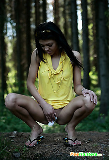 Watch a skinny exotic brunette piddle in the woods