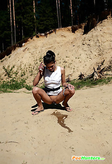 Watch brunette's river of piss flow through sand