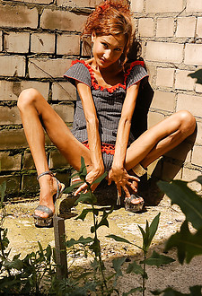Absolute skinny chick in high heels posing outdoor