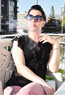 Brunette babe smoking at the terrace