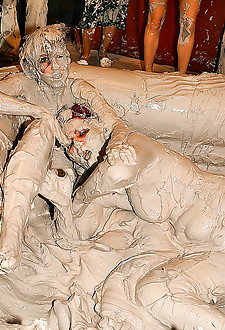 Hot babes tearing off their tops while wrestling in the mud