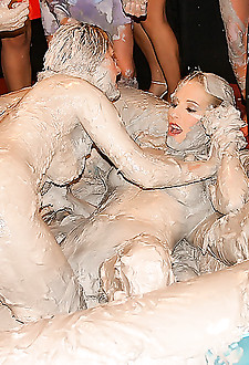 Erotic chicks wrestling each other and covered in thick mud