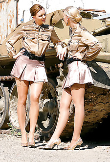 Two very horny lesbians fucking on a large tank outside