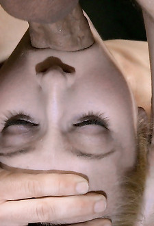 Petite deepthroat champ Odette Delacroix shackled to fucking machine and facefucked by hard cock