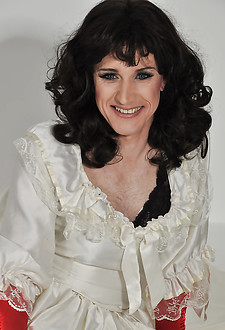 Beautiful naughty crossdresser wearing a long white wedding dress and horny satin gloves