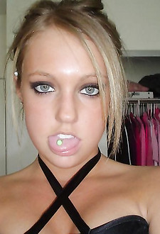 Four eyed blonde in high golfs and black lingerie poses