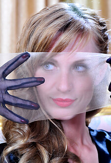 Pretty blonde in smooth lacy nylons trying on her new lingerie